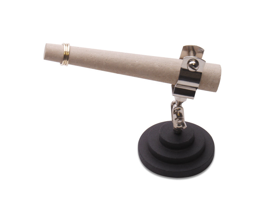 White ceramic mandrel held horizontally in a metal clamp on a black weighted base.