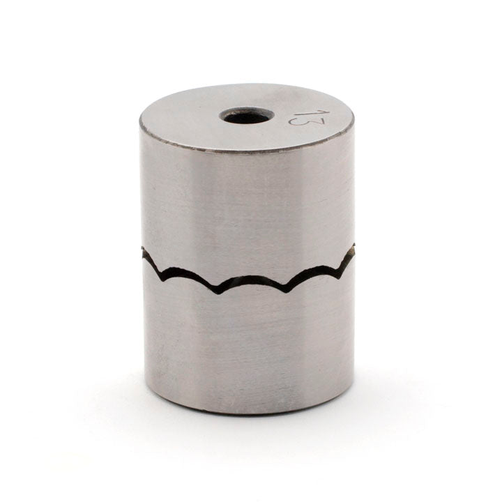 Cylindrical steel hoop-forming press die with a scalloped line around the middle and a hole through the top face.
