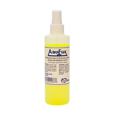 Spray bottle of pale-yellow Aquiflux liquid soldering flux.